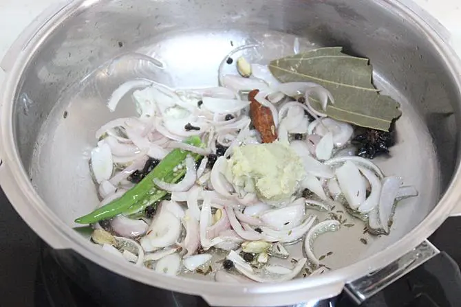 frying sliced onions in oil to make tomato bath recipe