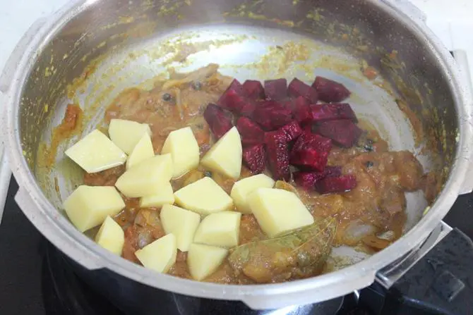 addition of veggies to the cooker for tomato bath recipe