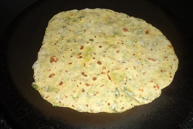 frying aloo methi paratha