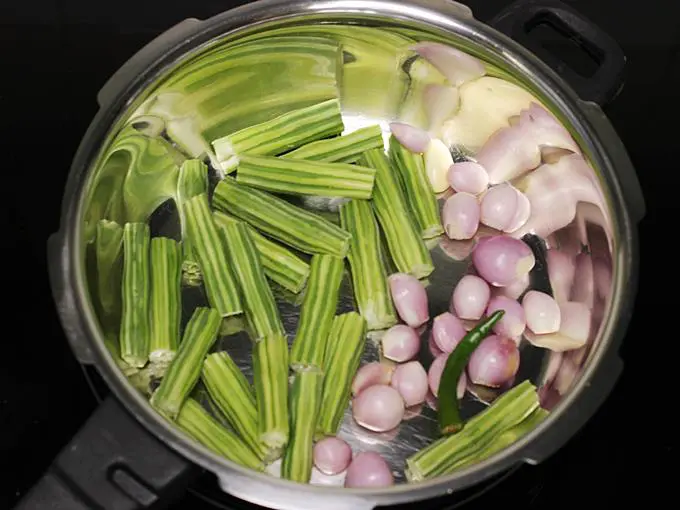 adding veggies to make drumstick sambar