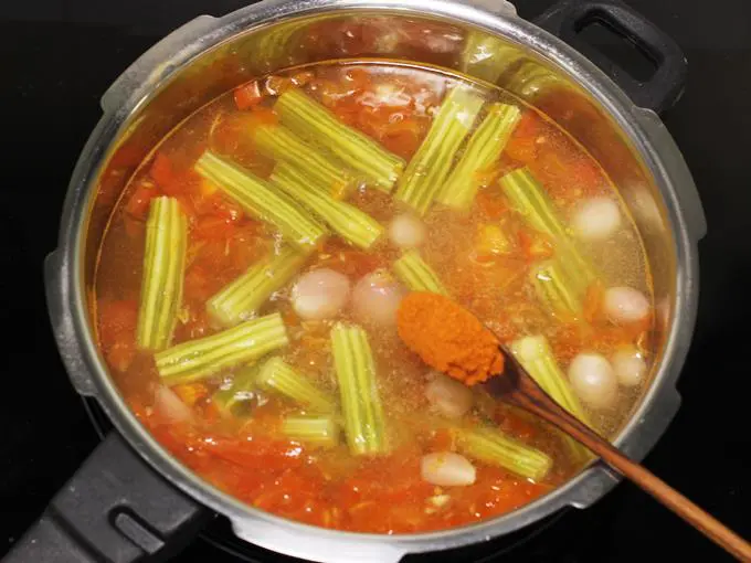 adding sambar powder