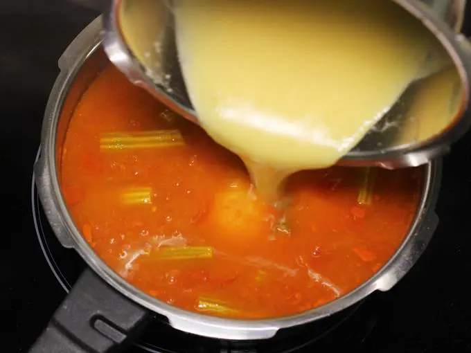 adding dal to make drumstick sambar