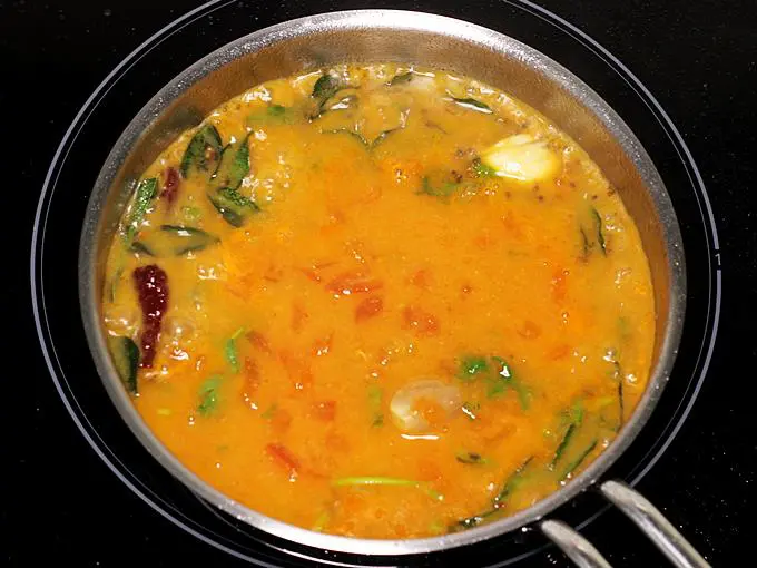 pouring drumstick sambar to tadka pan