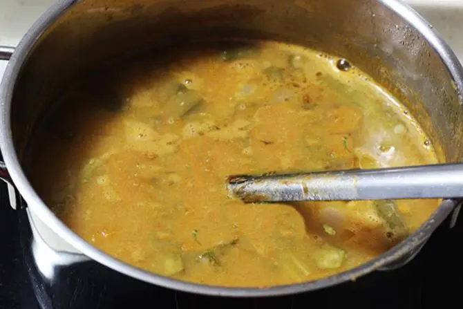 addition of coriander leaves to boiling sambhar