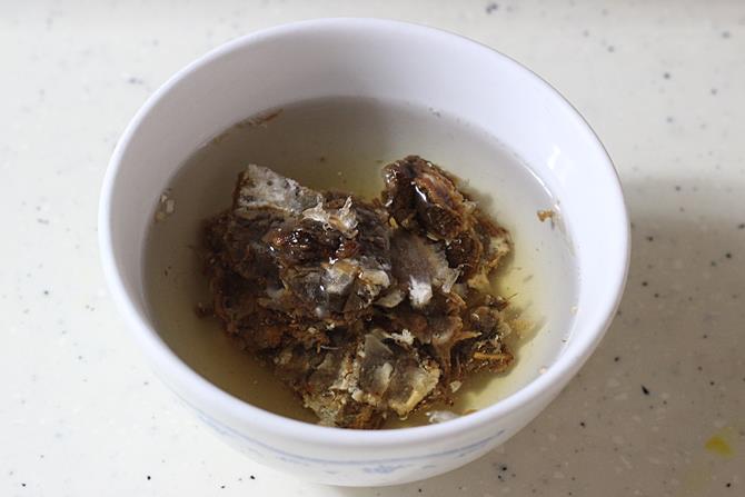 soaking tamarind in hot water for making sambhar