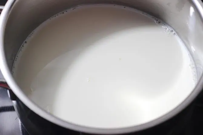 boiling milk in a pot to make shahi tukda recipe