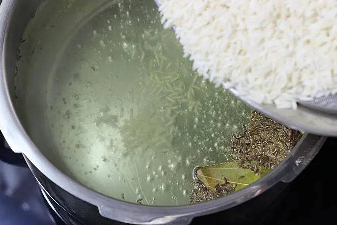 cooking biriyani rice with spices