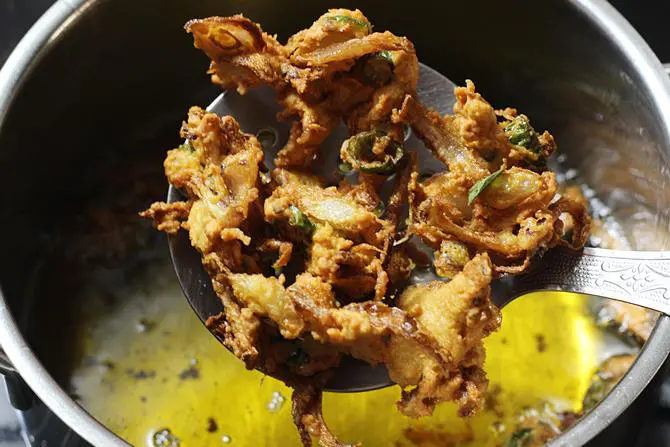 frying onion pakoda till golden