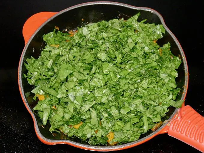adding spinach to make aloo palak