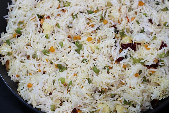 frying fried rice in a wok