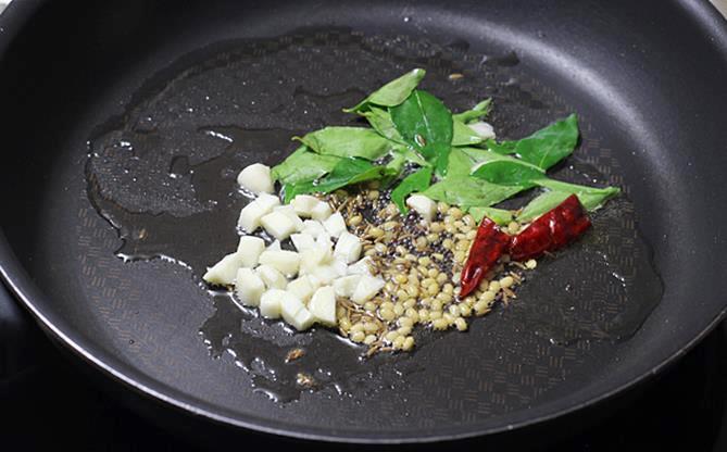 seasoning in oil with curry leaves for potato fry recipe