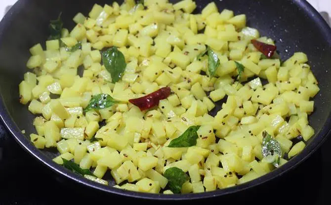 frying aloo on a low flame in potato fry recipe