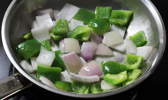 frying onions capsicum for making kadai chicken recipe
