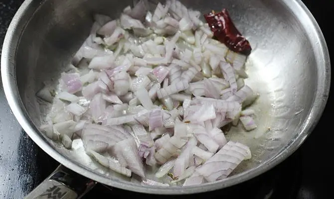 frying onions in pan for making kadai chicken recipe