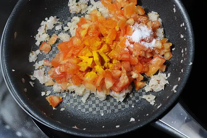 cooking tomatoes with salt turmeric to make mixed vegetable curry