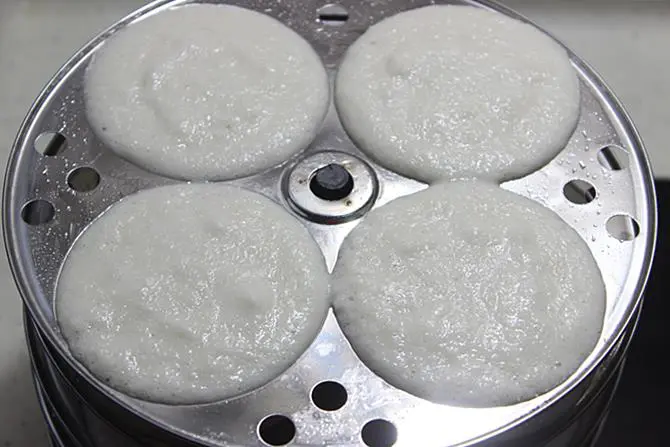 boiling water to steam in a pot for soft idli