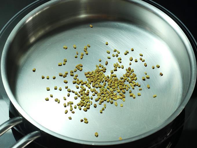 frying methi seeds to make rasam powder