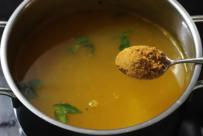 addition of water and rasam powder to make tomato rasam recipe