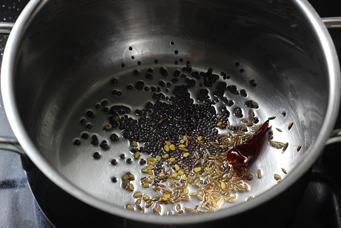 tempering cumin mustard hing in oil to make tomato rasam recipe