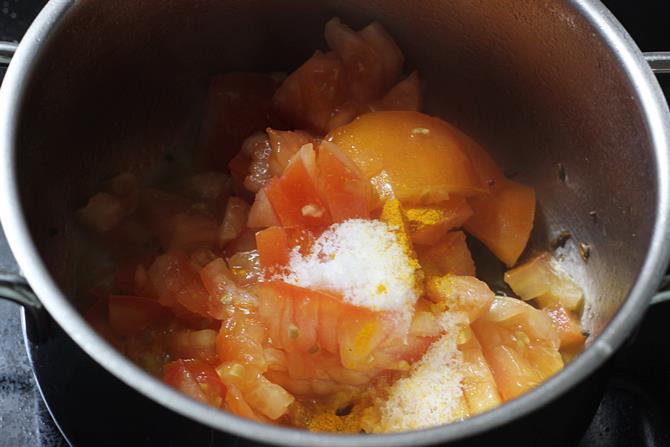 addition of chopped tomatoes salt to the pan to make tomato rasam