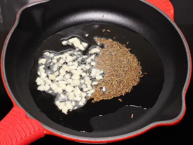 frying garlic cumin to make bhindi ki sabji