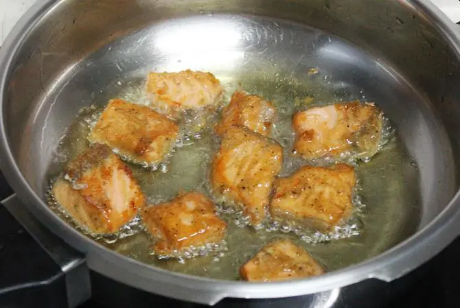 deep frying marinated fillets to make amritsari fish fry