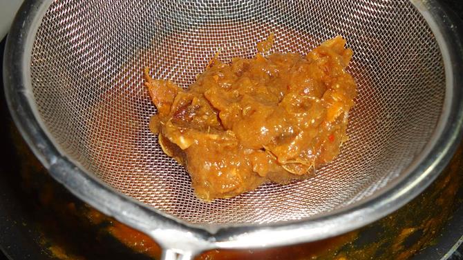 mashing soaked tamarind for tomato pickle tomato achar