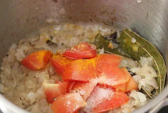 frying tomatoes to make gravy for paneer korma