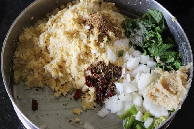 adding masala to ground dals to make dal vada