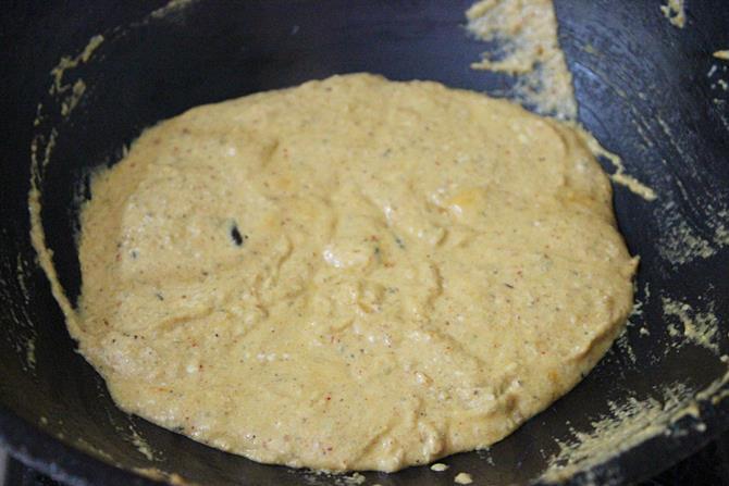 cooking the mixture until thick to make shahi paneer