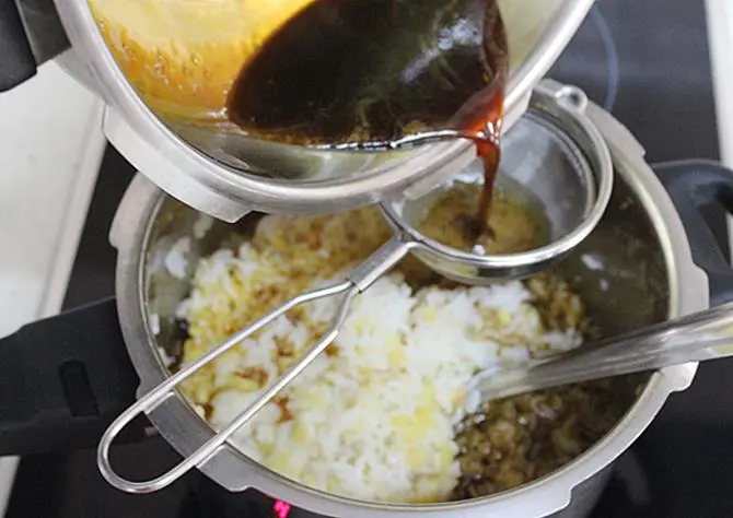 filtering jaggery syrup to make chakkara pongal