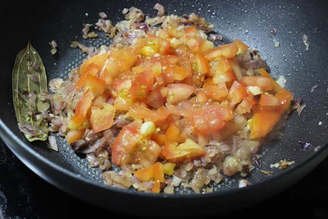 frying chopped tomatoes for making egg masala