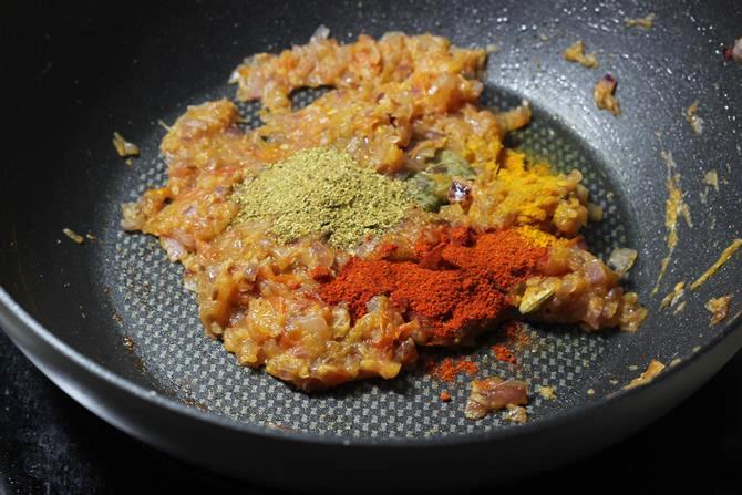 addition of spice powders to onion tomato to make egg masala