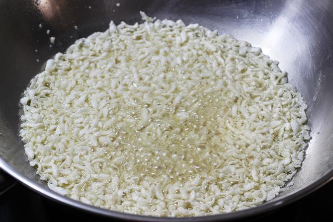 deep frying cleaned aval in oil to make poha chivda