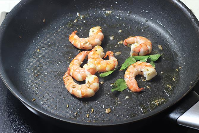 sauteing prawns for 2 minutes to prepare prawn curry recipe