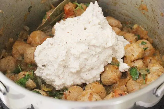 adding yogurt coconut to make soya chunks curry