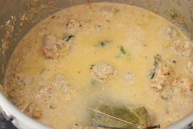 adding water to make gravy for soya chunks curry