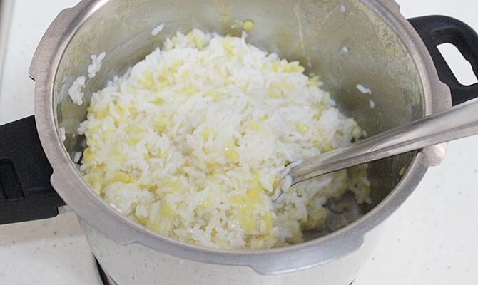 mashing rice dal for sweet pongal recipe