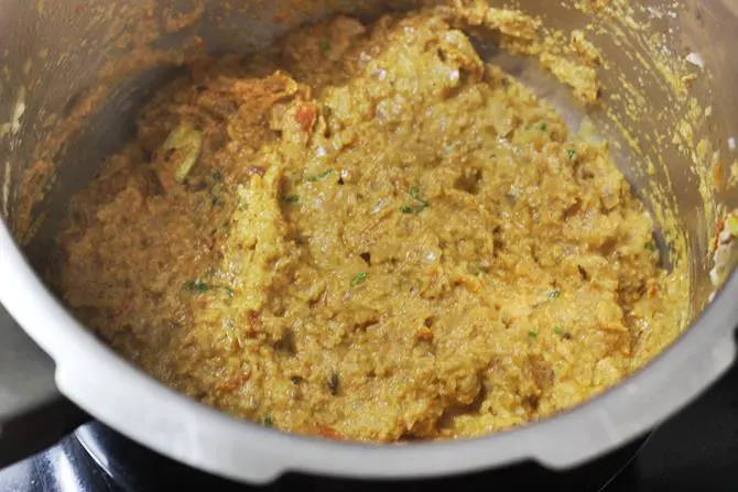 frying coconut with onion tomato mixture