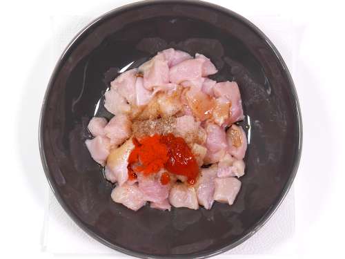 adding ingredients to marinate the chicken