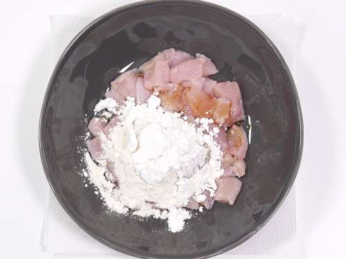 adding flour to the mixing bowl