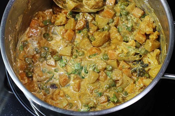 spreading vegetable gravy for making hyderabadi veg dum biryani