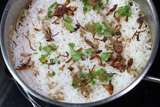 layering rice over veggies for hyderabadi veg dum biryani