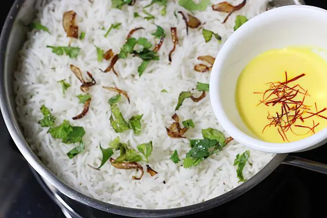 addition of rice, herbs for making hyderabadi dum biryani
