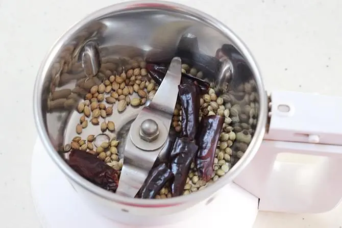 add spices to a grinder