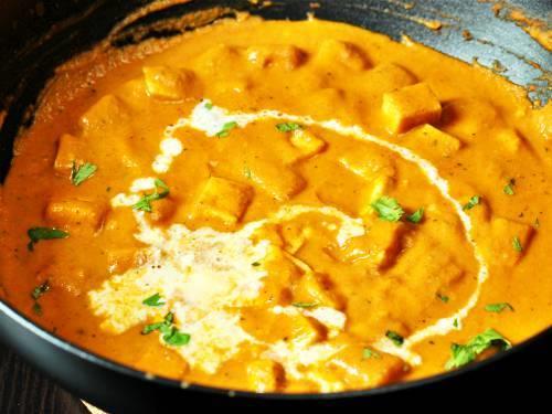 adding cream to paneer butter masala