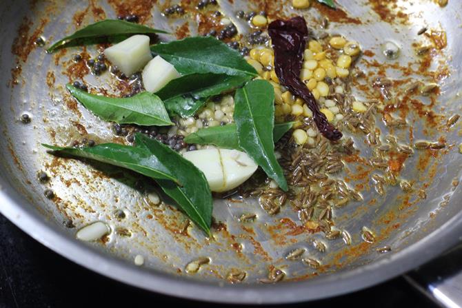 making tadka with curry leaves for ridge gourd chutney