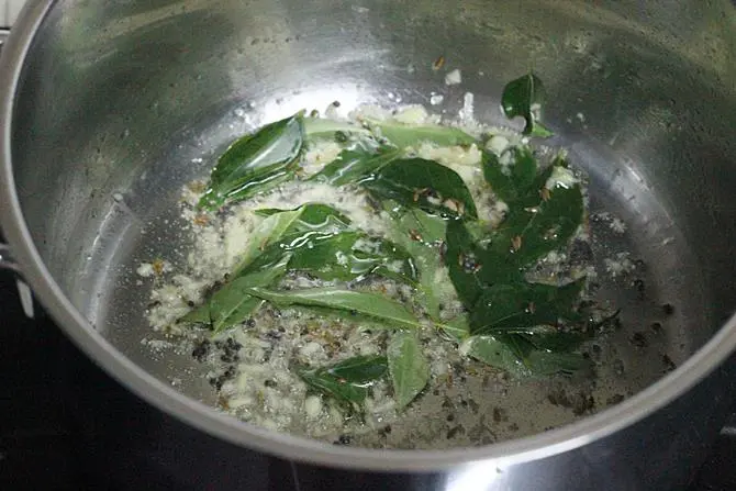 tempering cumin mustard in pan for sweet potato curry recipe