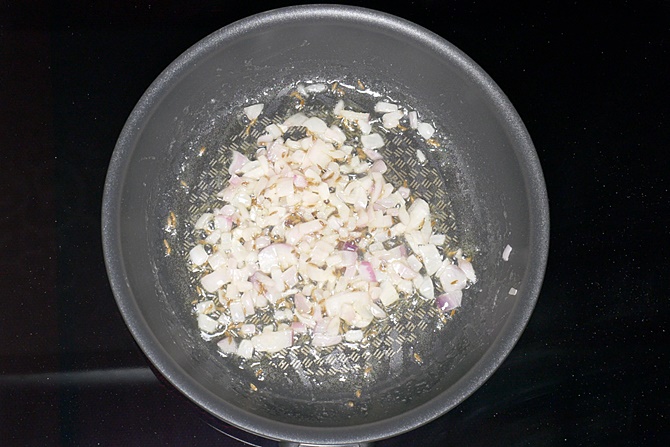 frying onions in pan to make tawa pulao