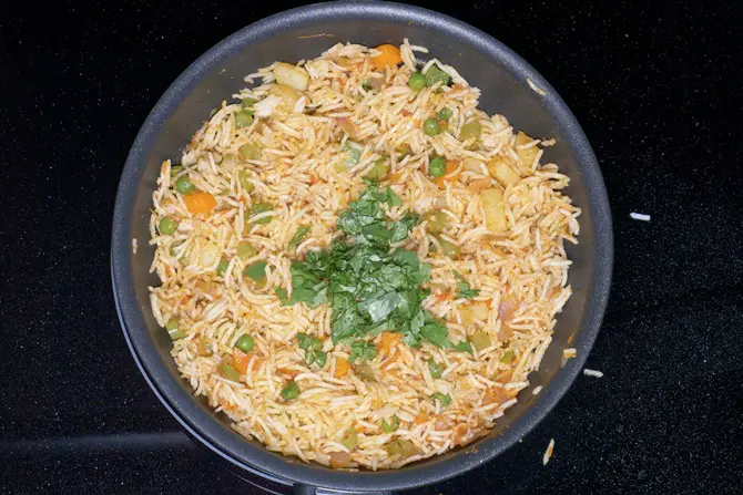 adding herbs to make tawa pulao